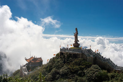 Statue of building against cloudy sky