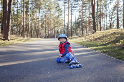 Portrait of girl sitting on road