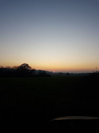 Scenic view of silhouette landscape against clear sky during sunset