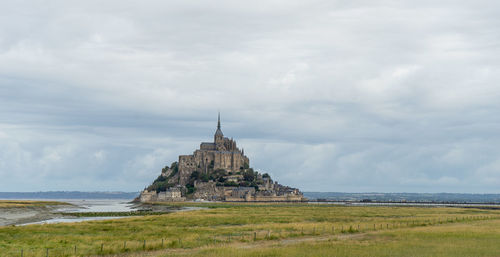 View of temple against cloudy sky