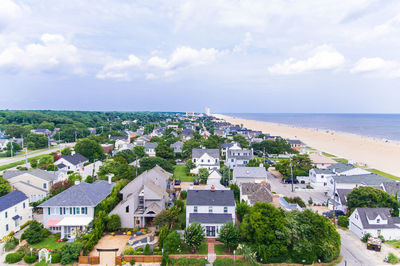 High angle view of buildings and sea against sky