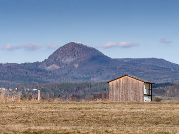 Built structure on field against sky