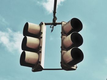 Low angle view of stoplight against blue sky