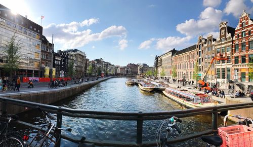 Boats in city against sky