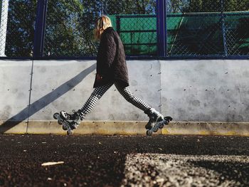 Side view of woman walking on street