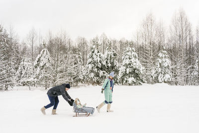 Playful parents with daughter in winter