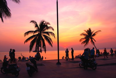 People on promenade against sky during sunset