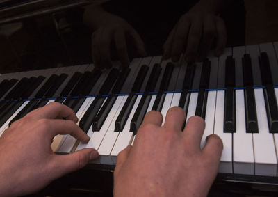 Midsection of person playing piano