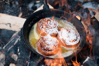 High angle view of cinnamon rolls in a pan on grill