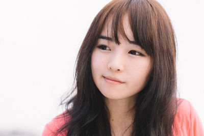 Close-up portrait of a beautiful young woman over white background