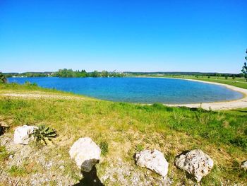 Scenic view of sea against clear blue sky