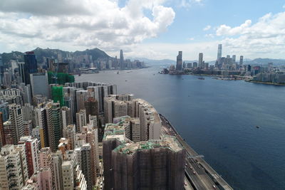 Panoramic view of bay and buildings against sky