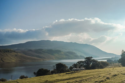 Scenic view of mountains against cloudy sky