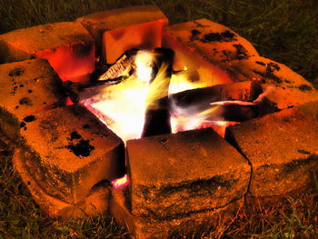 Close-up of bonfire on field at night
