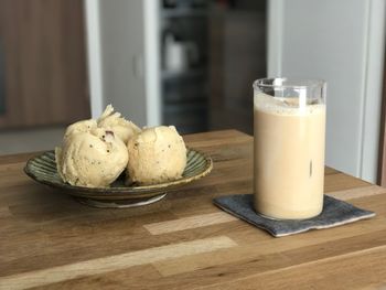 Close-up of japanese steamed bread and iced coffee in glass on table