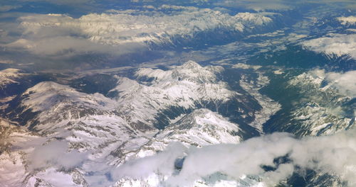 Aerial view of snowcapped mountains against sky