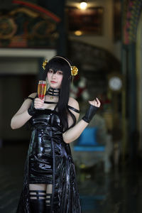 Young woman drinking water in city