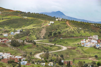 High angle view of houses and agricultural field against sky