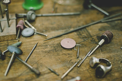 High angle view of jewelry making tools on workbench in workshop