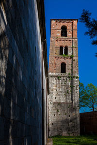 Low angle view of historic building against blue sky