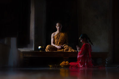 Women sitting on table at home