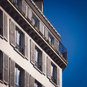 Low angle view of building against clear blue sky