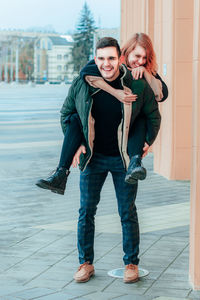 Portrait of young couple standing outdoors