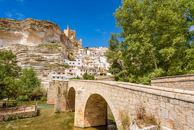 Alcala del jucar, spain. white village with a stone bridge over a river