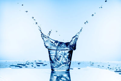 Close-up of water splashing against blue background