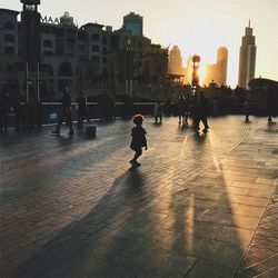 People on street in city against sky