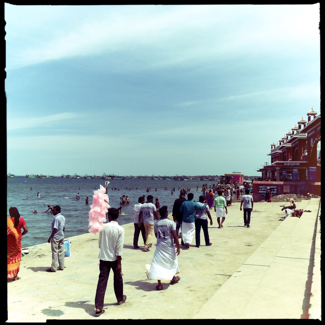 PEOPLE ON BEACH AGAINST SKY