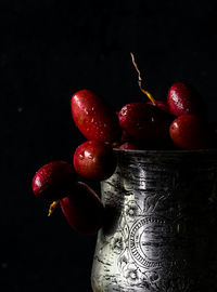 Close-up of cherries against black background