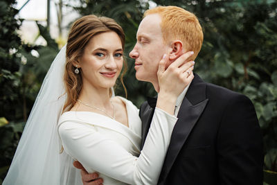 Portrait of smiling couple in tropical garden