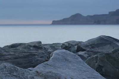 Rocks on beach against sky