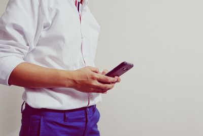 Midsection of man using mobile phone