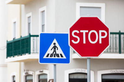 Close-up of road sign against built structure