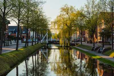 Bridge over canal in city against sky