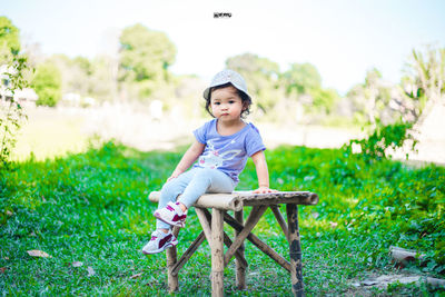 Portrait of girl sitting on grass