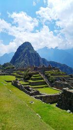 Scenic view of mountains against cloudy sky