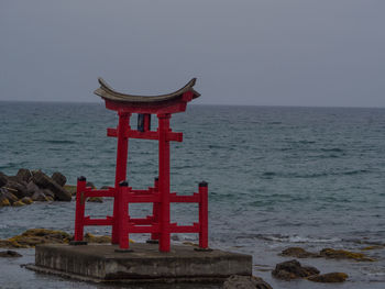 Lifeguard hut on sea against clear sky