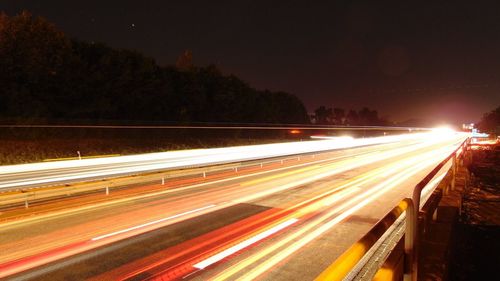 High angle view of light trails on highway at night