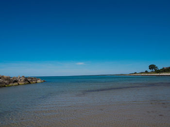 Scenic view of sea against clear blue sky