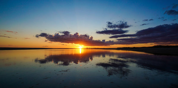 Scenic view of lake against sky during sunset