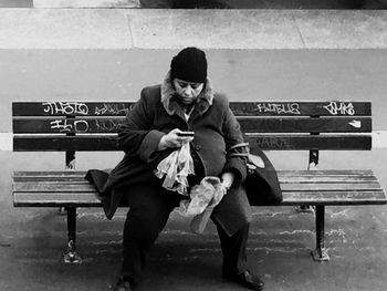 Full length of couple sitting on bench