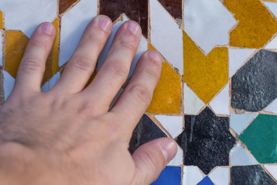 Cropped hand of woman holding paper