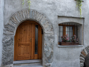 Closed door of building with window near