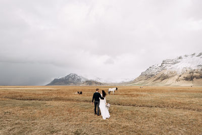 Man on field against sky