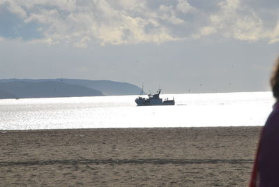 Man on beach against sky