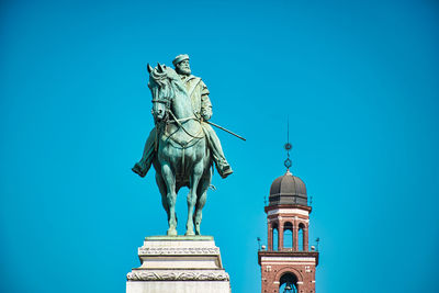 Low angle view of statue against blue sky