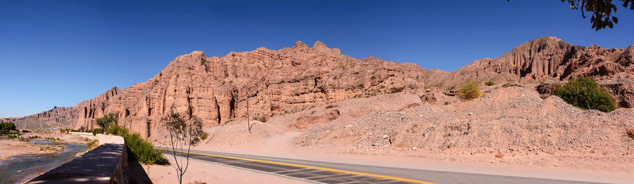 Scenic view of mountains against clear blue sky